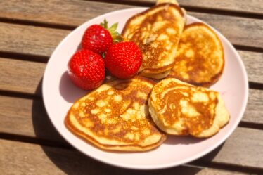 a plate of pancakes and strawberries