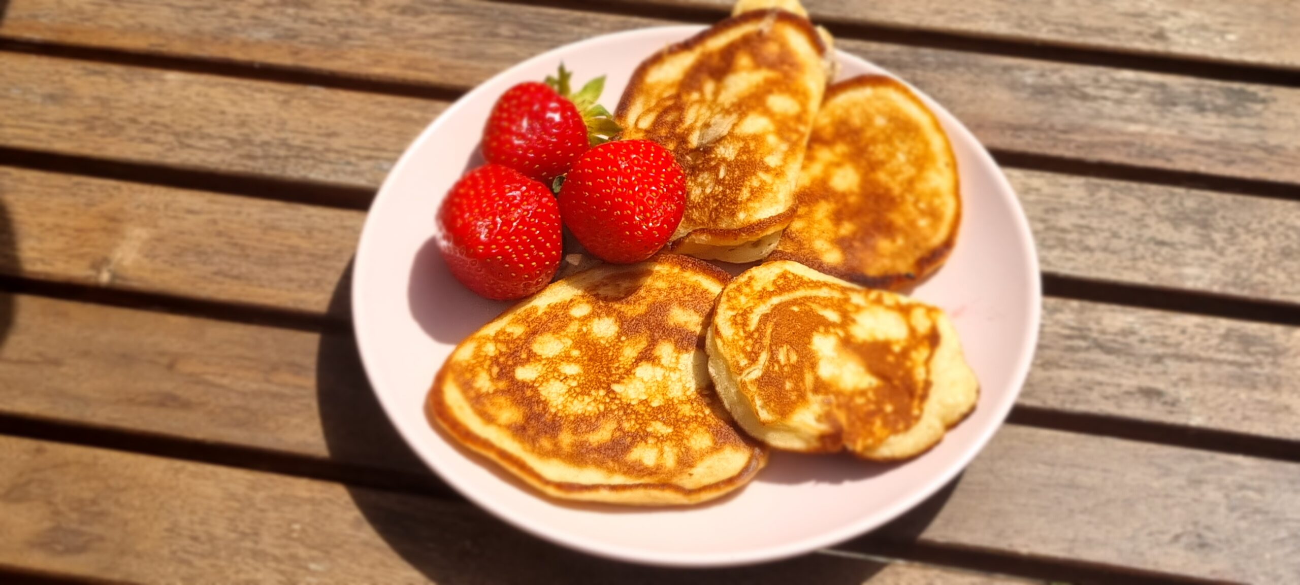 a plate of pancakes and strawberries